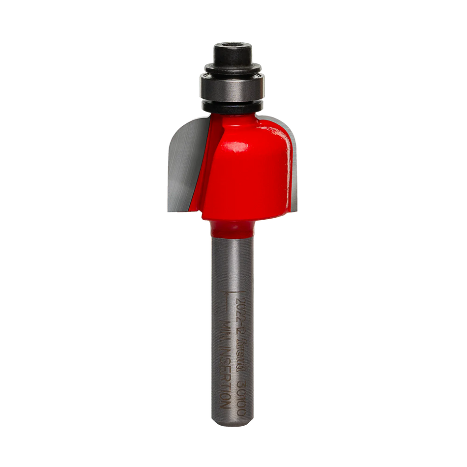 A high-quality studio photograph of the Freud 30-100 cove router bit, showing its red body, sharp carbide cutting edges, top-mounted steel ball bearing, and a 1/4 inch polished shank.