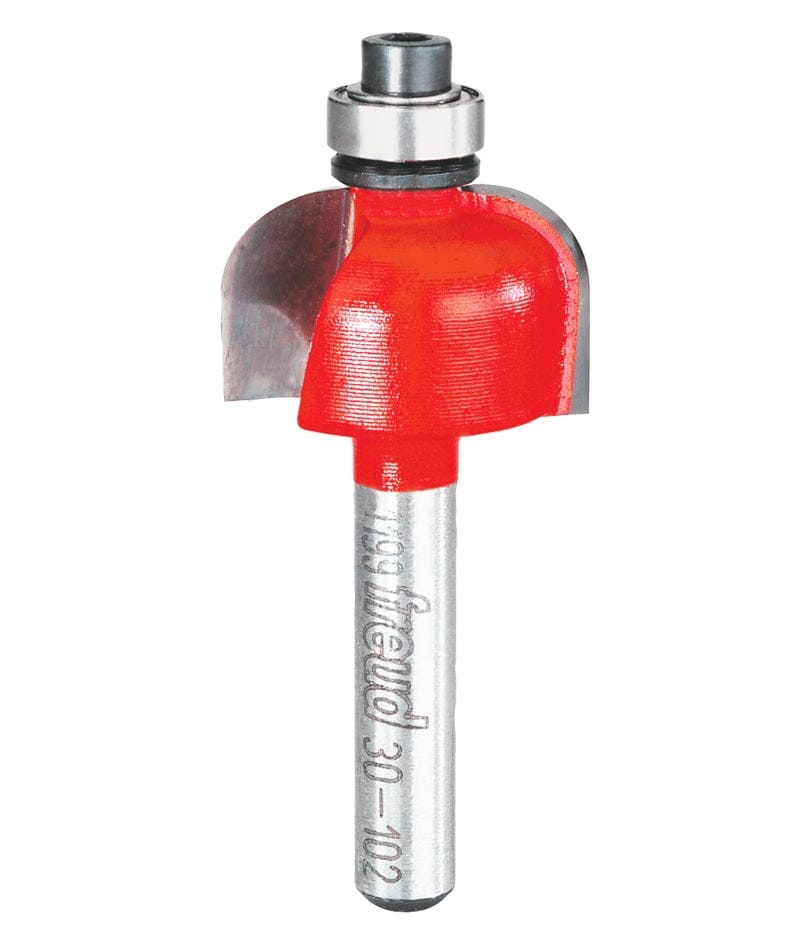 A professional studio photograph of the Freud 30-102 cove router bit, showcasing its bright red body, sharp silver carbide cutting edges, top-mounted steel ball bearing, and a polished 1/4 inch shank.