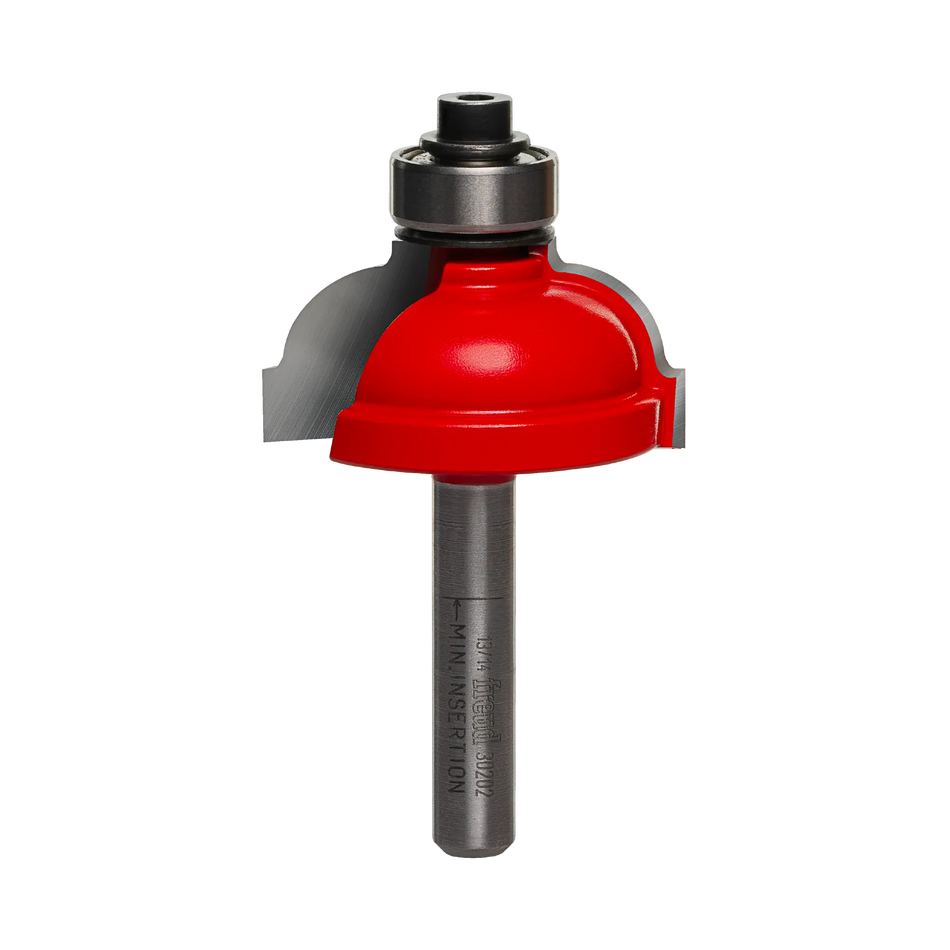 Studio shot of the Freud 30-202 Cove and Fillet router bit featuring a red Perma-SHIELD body, two carbide cutters, 1/4 inch silver shank, and top ball bearing guide.