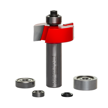 A professional studio photograph of the Freud 32-522 multi-rabbet router bit, showcasing its red Perma-SHIELD coating on the cutting head, silver TiCo carbide edges, and a polished 1/2-inch steel shank, shown alongside its included interchangeable ball bearings of various diameters.