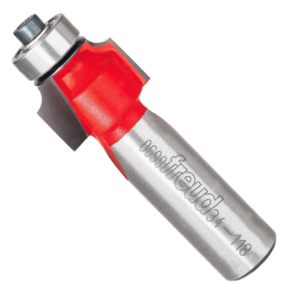 A professional studio product shot of the Freud 34-118 carbide rounding over router bit shown at an angle, featuring the signature red Perma-SHIELD non-stick coating, a ball-bearing guide, and a polished 1/2-inch steel shank.
