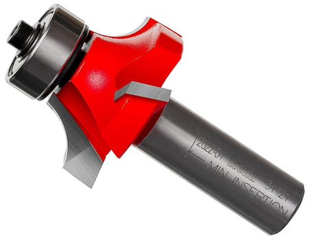 A professional studio product shot of the Freud 34-124 carbide rounding over router bit shown at an angle, featuring the signature red Perma-SHIELD non-stick coating on the four-cutter Quadra-Cut head and a polished 1/2-inch steel shank.