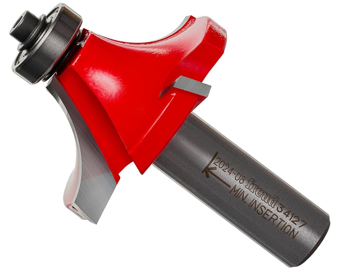 A professional studio product shot of the Freud 34-127 carbide rounding over router bit shown at an angle, featuring the signature red Perma-SHIELD non-stick coating on the four-cutter head and a polished 1/2-inch steel shank.