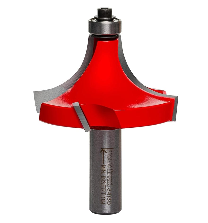 Studio shot of the Freud 34-130 Rounding Over Router Bit featuring a red Perma-SHIELD coated body, a 1/2-inch shank, and a silver ball bearing pilot at the top. The bit showcases the four-cutter Quadra-Cut design.