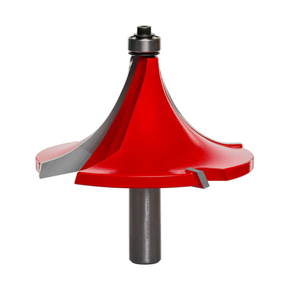 Studio shot of the Freud 34-140 rounding over router bit, featuring a massive red body with a 1-1/2 inch radius profile, 1/2 inch shank, and the signature Quadra-Cut four-wing cutter design.