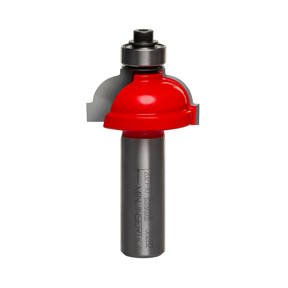 Studio shot of the Freud 38-282 Cove and Fillet router bit featuring a red Perma-SHIELD body, two carbide cutters, 1/2 inch silver shank, and top ball bearing guide.
