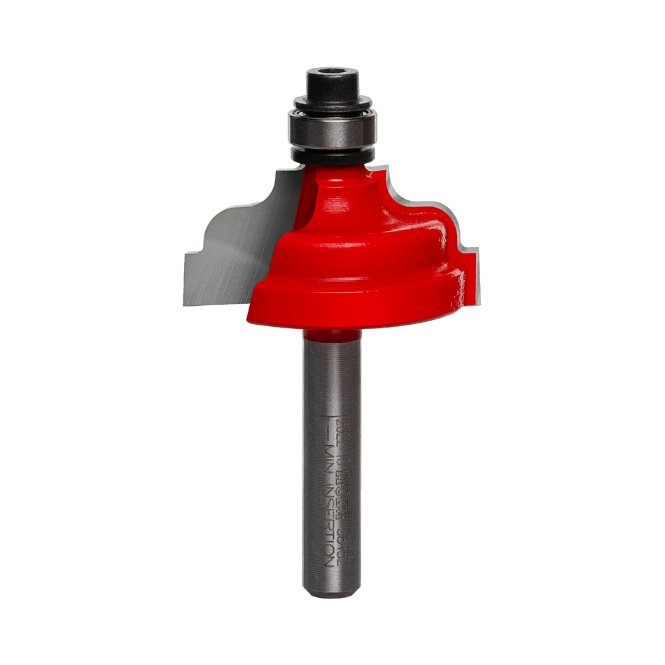 Studio shot of the Freud 38-452 Double Fillet Ogee router bit featuring a red Perma-SHIELD body, Quadra-Cut carbide cutters, 1/4 inch silver shank, and top ball bearing guide.