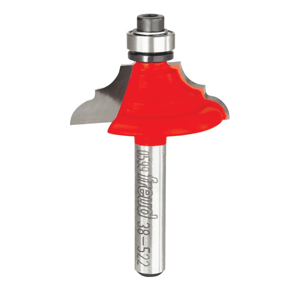 A professional studio photograph of the Freud 38-522 decorative edging bit, featuring its bright red Perma-SHIELD coating on the cutting head, sharp silver Quadra-Cut carbide edges, a top-mounted ball bearing pilot, and a polished 1/4 inch steel shank.