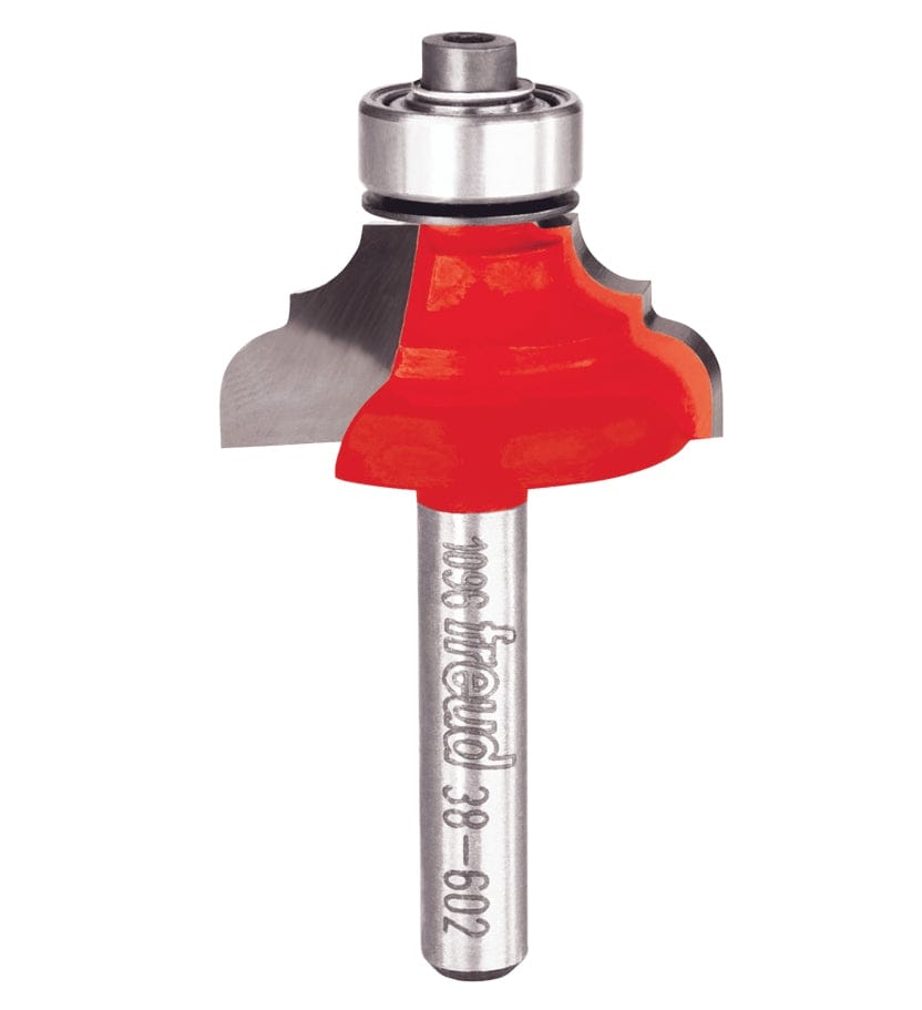 A professional studio photograph of the Freud 38-602 classical cove and round router bit, featuring its signature red Perma-SHIELD coating on the cutting head, silver Quadra-Cut carbide edges, a top-mounted ball bearing pilot, and a polished 1/4 inch steel shank.