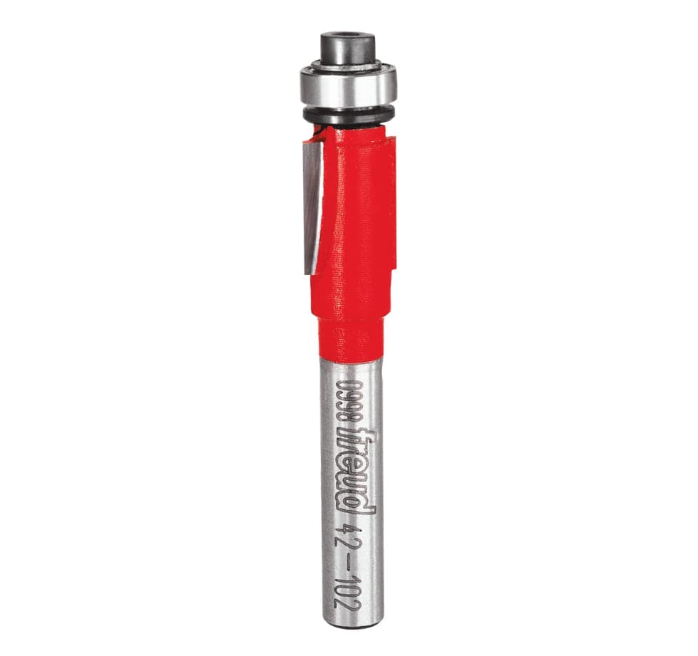 Studio shot of the Freud 42-102 Flush Trim router bit featuring a red Perma-SHIELD body, two straight carbide cutters, 1/4 inch silver shank, and a top-mounted ball bearing pilot.
