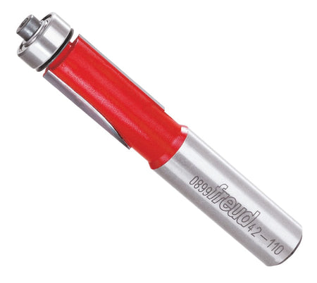 Angled view of the Freud 42-110 1/2 inch bearing flush trim router bit with a top-mounted ball bearing, red Perma-SHIELD coating, and silver 1/2 inch shank.