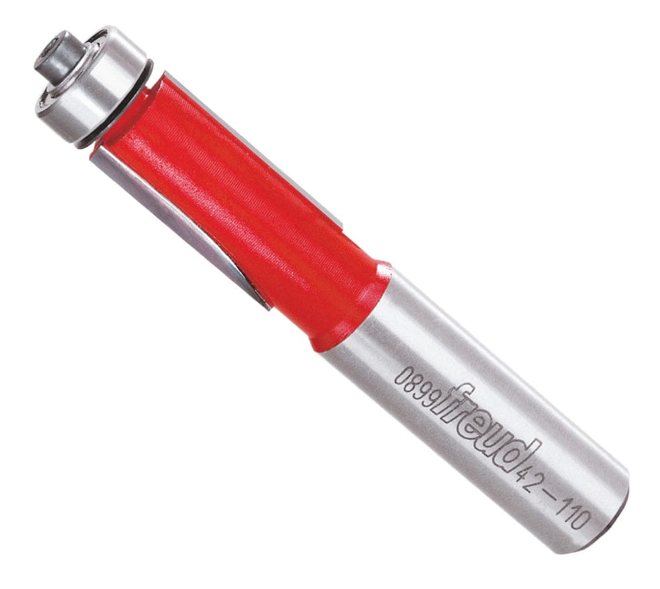 Angled view of the Freud 42-110 1/2 inch bearing flush trim router bit with a top-mounted ball bearing, red Perma-SHIELD coating, and silver 1/2 inch shank.