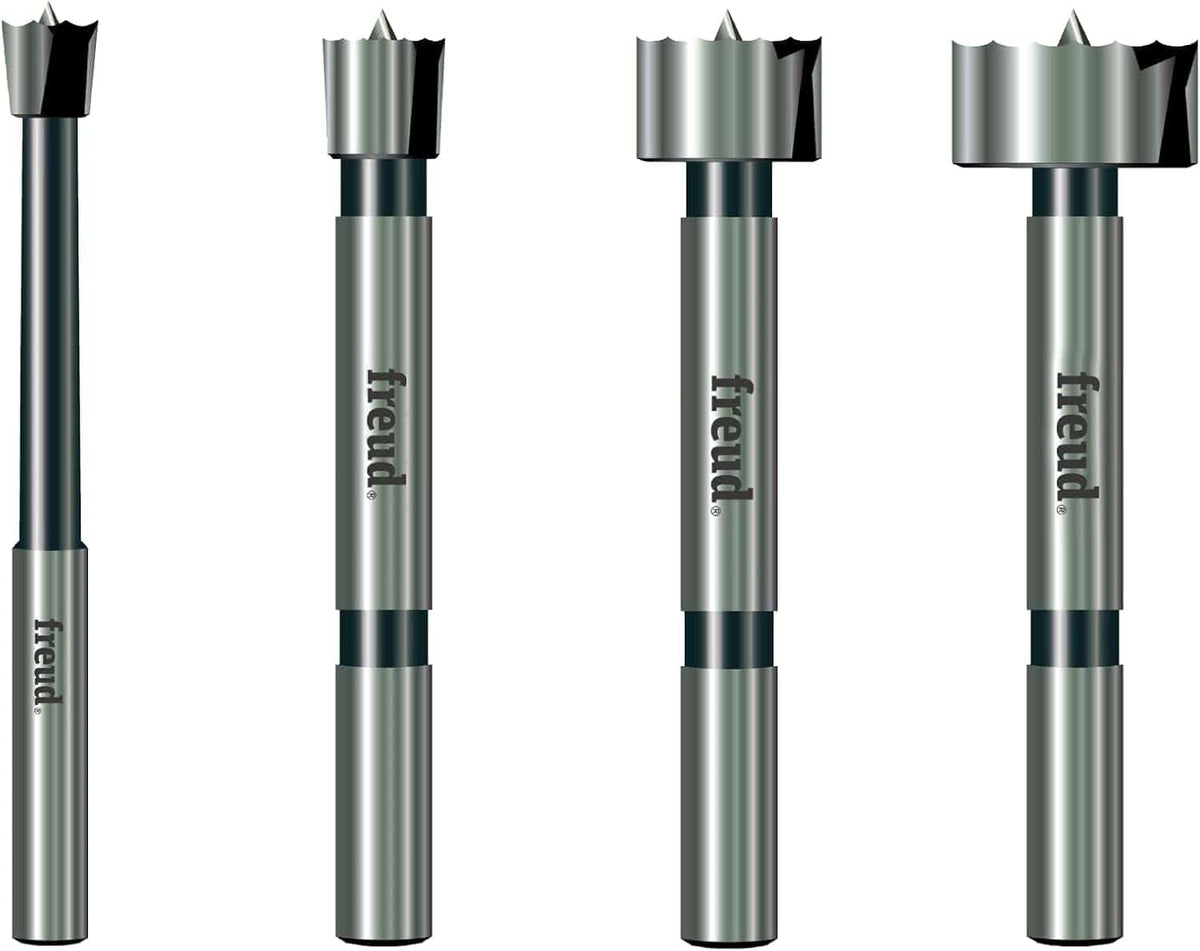 A professional product illustration of the four carbide Forstner bits included in the Freud PB-104 set, showing the progression of sizes with high-quality forged steel shanks and precision shear serrated edges.