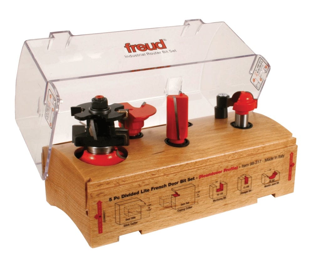 The Freud 5-piece Divided Lite French Door Bit Set (Roundover Profile) displayed in its wooden storage case with a clear plastic lid, showing the five carbide-tipped bits.