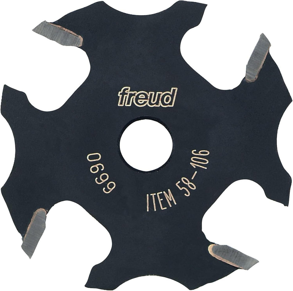 A studio product shot of the Freud 58-106 4-wing slotting cutter, featuring a black-coated body with four silver carbide cutting tips and a center bore for arbor mounting.