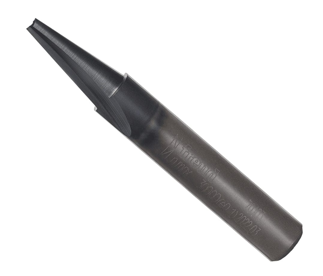 An overhead angled studio product shot of the Freud 70-103 solid carbide carving tool, demonstrating its sharp single-flute V-groove configuration, a solid unpainted industrial steel shank with stamped manufacturer parameters, and a highly polished cutting tip.