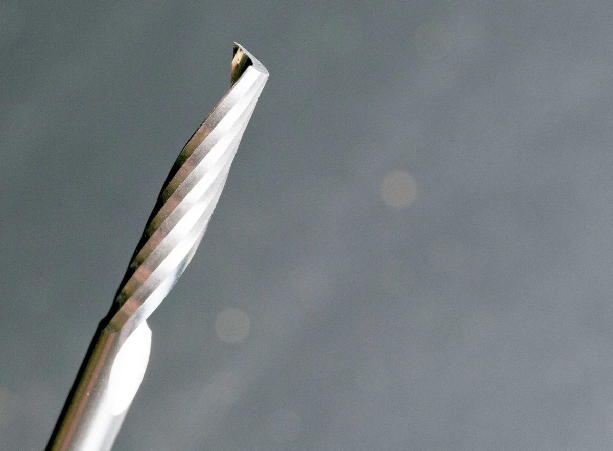 A detailed perspective shot of the spiral cutting edge and the point of the solid carbide O-flute up spiral bit, illustrating the precision engineering for CNC plastic fabrication.