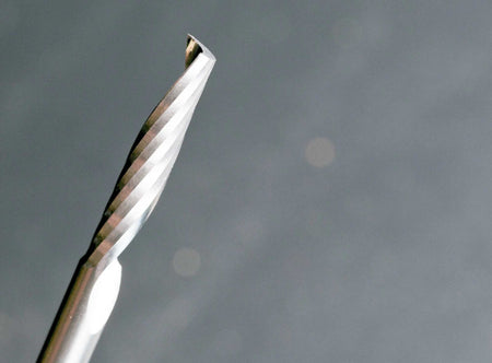 A detailed perspective shot of the spiral cutting edge and the point of the solid carbide O-flute up spiral bit, illustrating the precision engineering for CNC plastic fabrication.