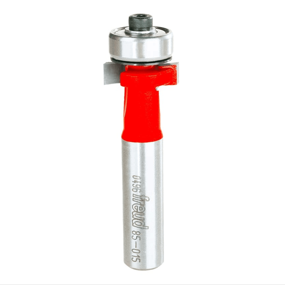 Studio shot of the Freud 85-015 inlay router bit standing upright, featuring a red body, carbide cutters, and a top-mounted ball bearing guide on a 1/2 inch shank.