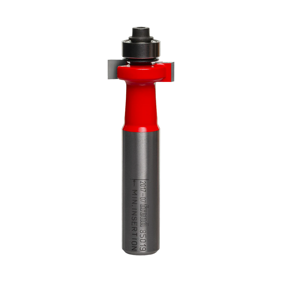 Studio shot of the Freud 85-019 solid surface inlay router bit standing upright, featuring a red body, carbide cutters, and a top-mounted ball bearing guide on a 1/2 inch shank.