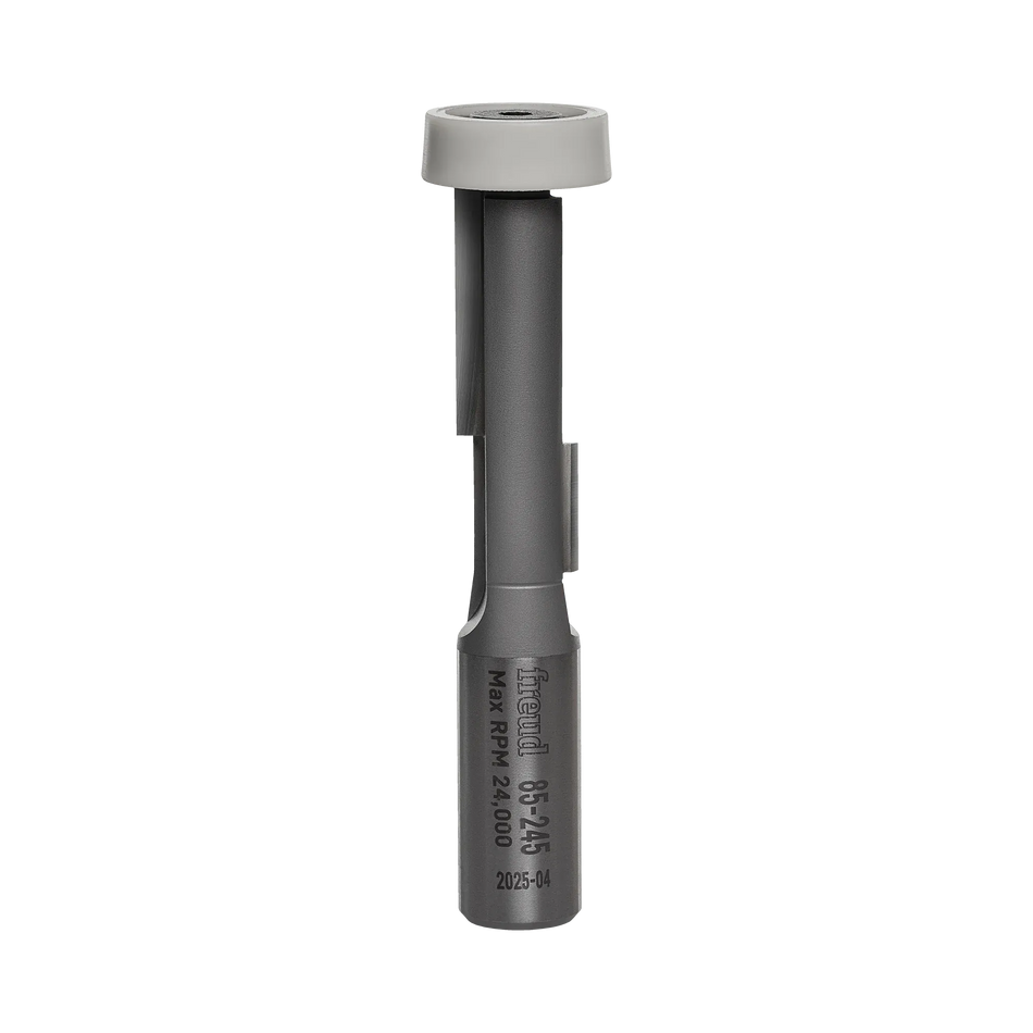 Studio shot of the Freud 85-245 router bit showing the grey steel body, carbide cutting edges, and white synthetic bearing at the top.