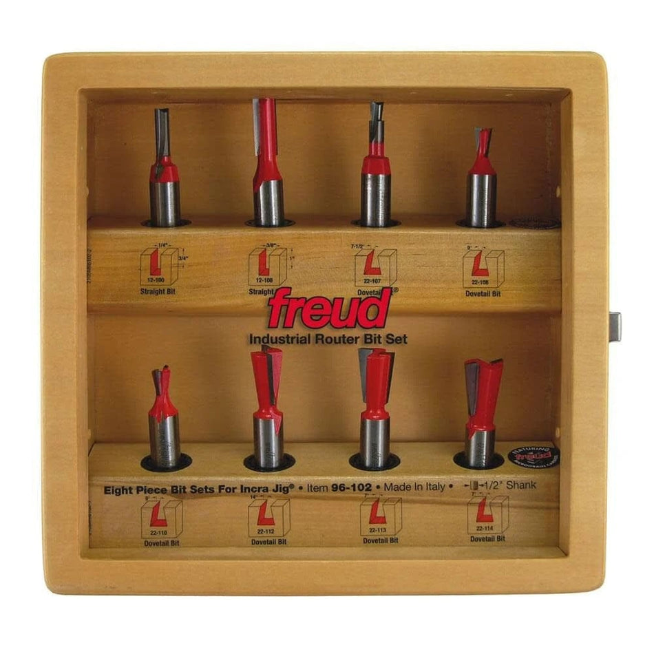 Front view of the Freud 96-102 8-piece router bit set inside its wooden storage case with the bits organized in marked slots.