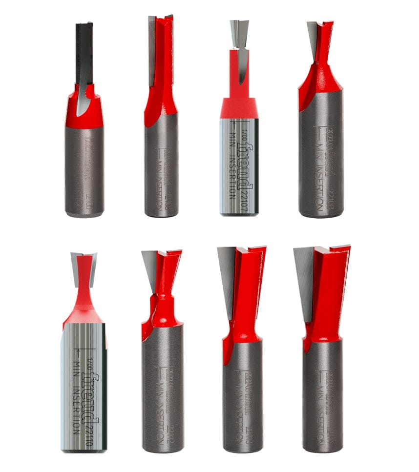 Studio view of the eight Freud router bits in the set arranged in two rows, showing the red Perma-SHIELD coating and carbide tips.
