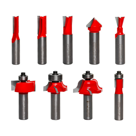 Image of nine Freud router bits arranged in two rows. Each bit has a unique cutting shape, including straight, V-groove, dovetail, rounding over, ogee, rabbeting, and flush trim profiles. Some bits include bearing guides for edge-following precision