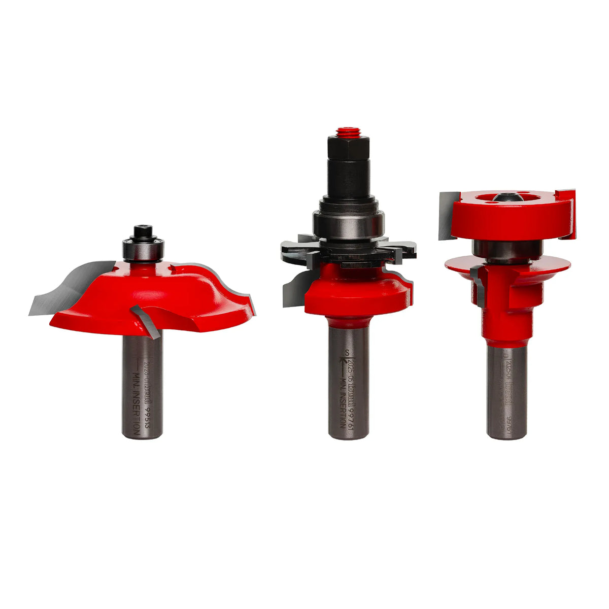 A direct studio product display shot of the Freud 97-276 3-Piece Premier Adjustable Cabinet Door Router Bit Set against a clean white background, showcasing the red Perma-SHIELD non-stick coated bodies, sharp micrograin carbide cutting teeth, and unpainted 1/2-inch steel shanks with laser-etched minimum insertion lines, arranged left to right as the Quadra-Cut ogee raised panel bit with a top guide bearing, the adjustable ogee cope rail bit with shims, and the matching adjustable ogee stick stile bit.