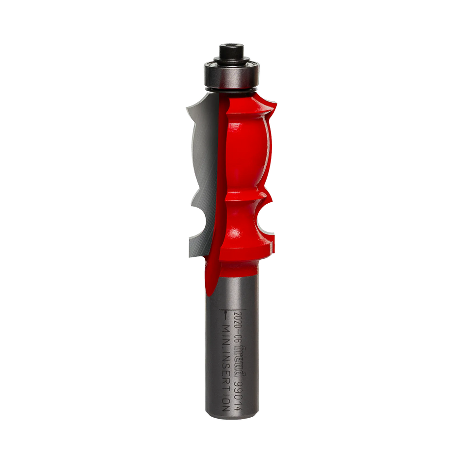 Studio shot of the Freud 99-014 face molding router bit standing upright, featuring a red Perma-SHIELD body, carbide cutters, and a top-mounted ball bearing guide on a 1/2 inch shank.