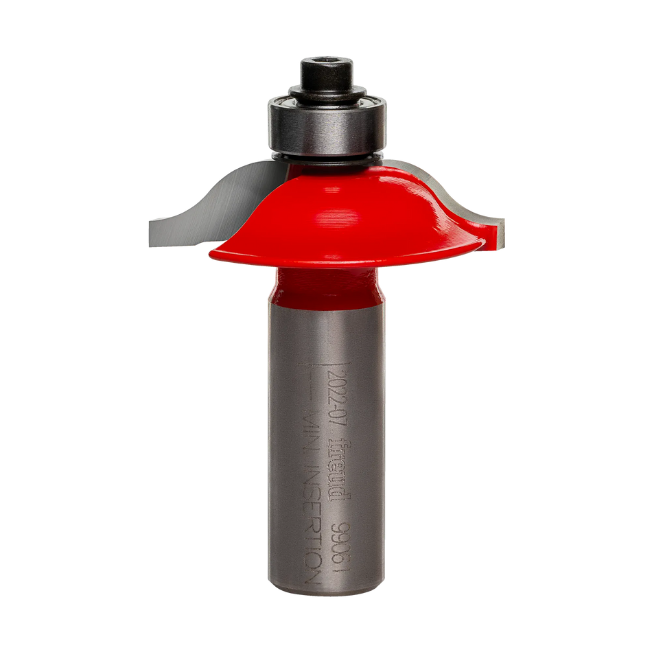 Studio shot of the Freud 99-061 rail and stile profile router bit standing upright, featuring a red Perma-SHIELD body with an ogee profile and top-mounted ball bearing guide on a 1/2 inch shank.
