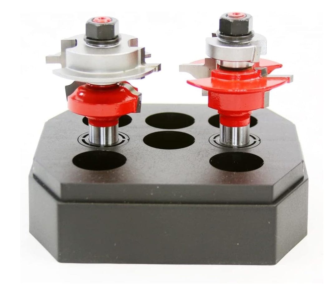 The two router bits displayed in a black storage stand, showing the difference in cutter height and profile geometry for the coping and sticking cuts.