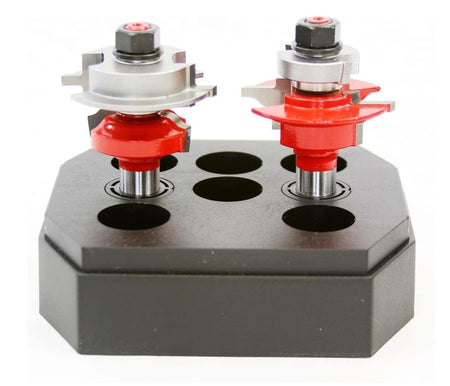 The two router bits displayed in a black storage stand, showing the difference in cutter height and profile geometry for the coping and sticking cuts.