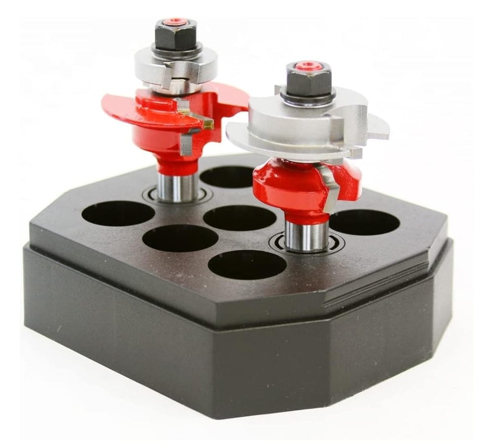 Angled view of the router bit set in a black holder, highlighting the carbide cutters and the top-mounted bearings.