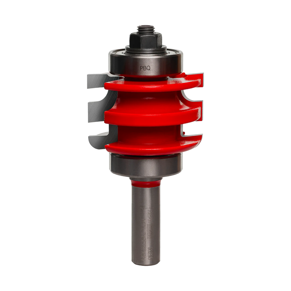 Studio shot of the Freud 99-290 one-piece rail and stile router bit standing upright, featuring a red Perma-SHIELD body with a beaded profile and ball bearing guides on a 1/2 inch shank.