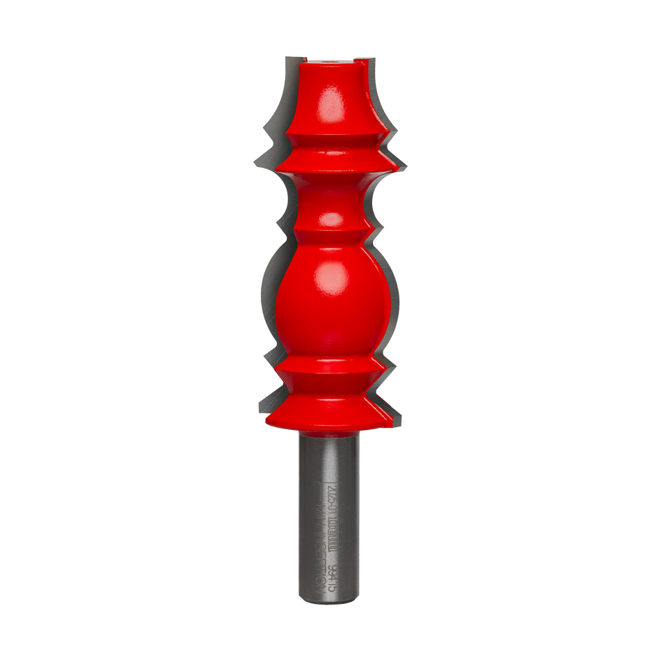 Studio shot of the Freud 99-415 wide crown molding router bit standing upright, featuring a tall red Perma-SHIELD body with carbide cutters on a 1/2 inch shank.