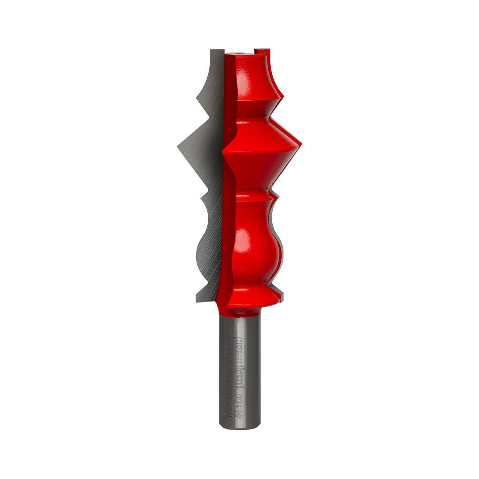Studio shot of the Freud 99-419 wide crown molding router bit standing upright, featuring a tall red Perma-SHIELD body with carbide cutters on a 1/2 inch shank.