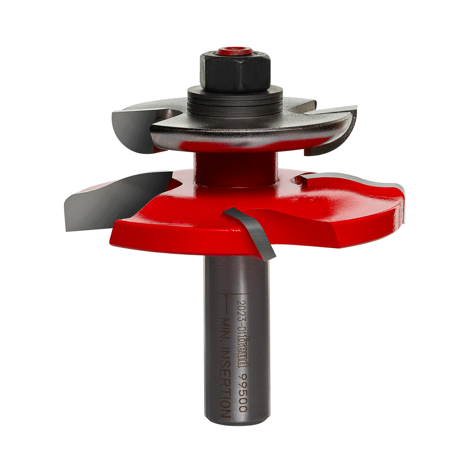 Studio shot of the Freud 99-500 raised panel router bit standing upright, featuring a red Perma-SHIELD coating, Quadra-Cut four-cutter design, and an integrated black back cutter on a 1/2 inch shank.