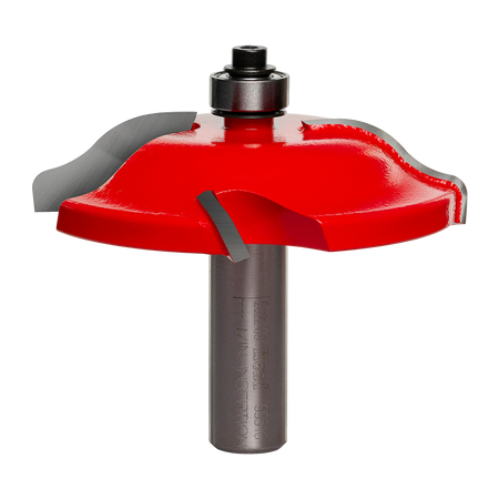 Studio angle view of the Freud 99-510 raised panel router bit, featuring a red body, Quadra-Cut four-wing carbide cutters, top-mounted bearing, and 1/2 inch shank.