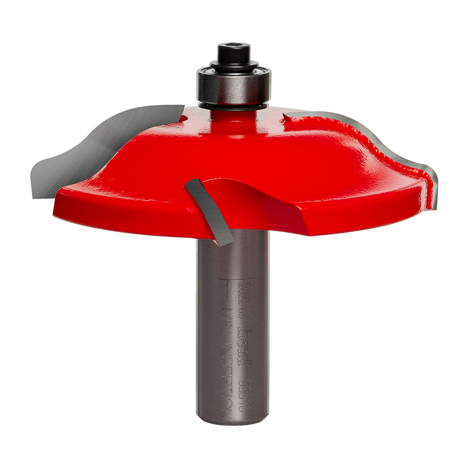 Studio angle view of the Freud 99-510 raised panel router bit, featuring a red body, Quadra-Cut four-wing carbide cutters, top-mounted bearing, and 1/2 inch shank.