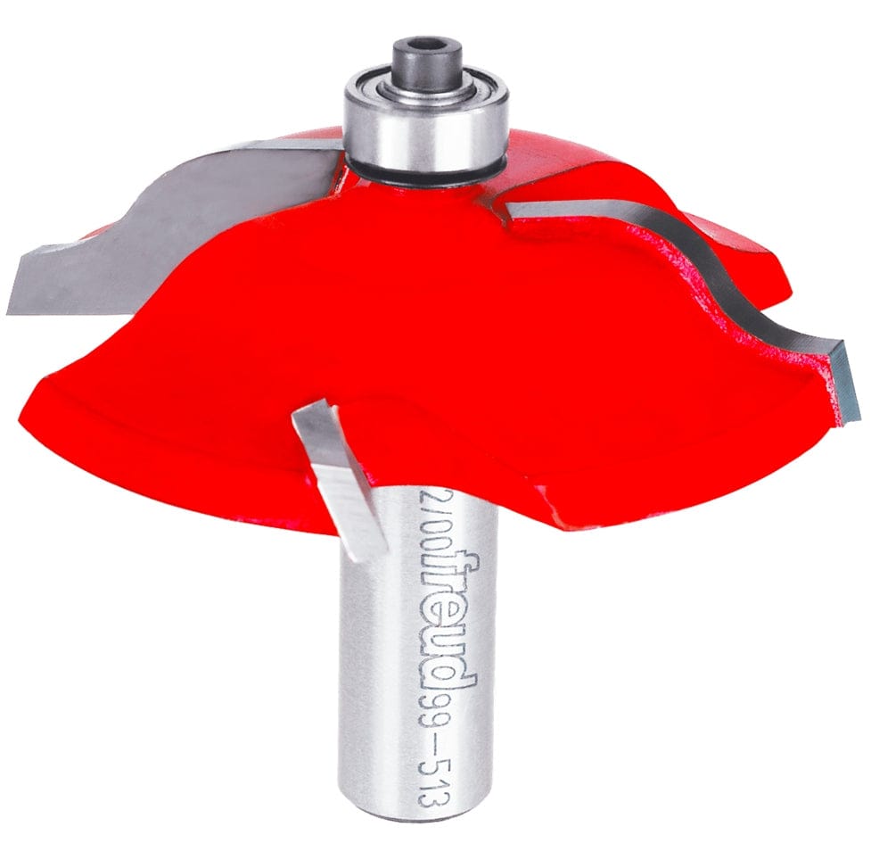 A professional studio shot of the Freud 99-513 2-3/4 inch Quadra-Cut raised panel router bit, featuring the signature red Perma-SHIELD non-stick coating, four carbide cutters, a ball-bearing guide, and a polished 1/2 inch steel shank.