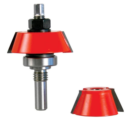 Studio shot of a Freud router bit standing upright, featuring a red body with angled carbide cutters and a top-mounted ball bearing, accompanied by a separate interchangeable cutter head.