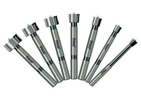 A professional product illustration of the seven carbide Forstner bits included in the Freud PB-107B set, displayed in a fan arrangement to show the progression of sizes from 1/4 inch to 1 inch.