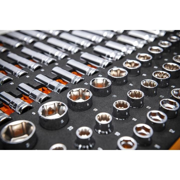 GEARWRENCH socket set displayed in a labeled tray with orange and white size markings. Includes 6-point and 12-point sockets in standard, deep, mid-length, flex, and stubby formats. Sockets are arranged in rows by type and size for easy identification