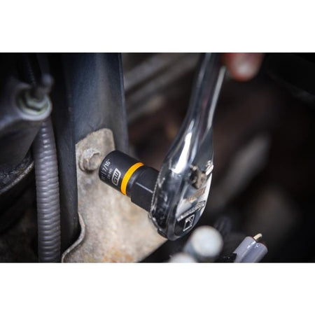 Close-up of a ratchet wrench tightening a 11/16" Chrome Vanadium socket onto a bolt mounted on a metal bracket, illustrating tool use in mechanical repair.