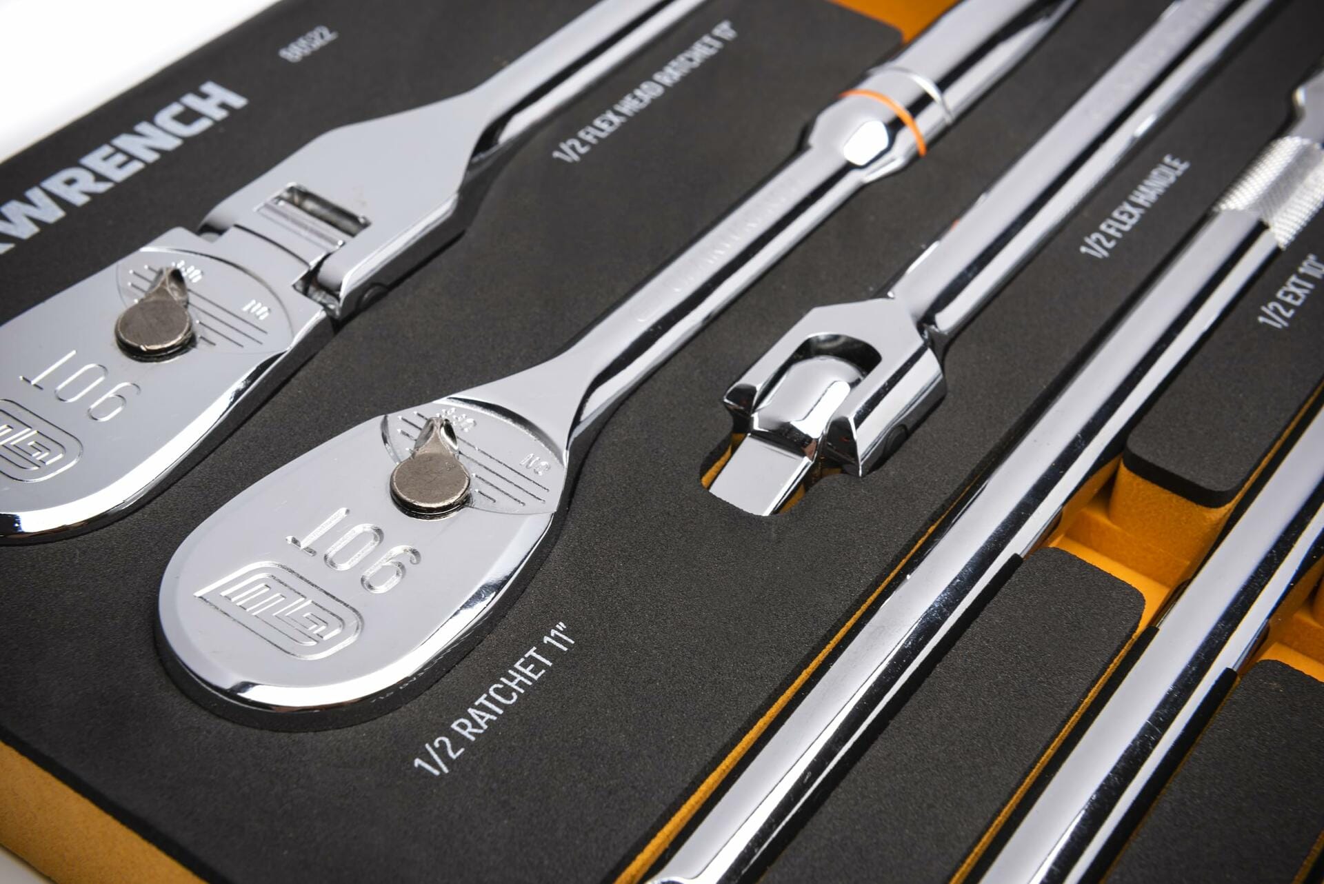 Close-up of chrome hand tools in a foam-lined tray labeled with tool names and sizes. Includes 1/2" ratchet, flex head breaker bar, extension bar, and flex handle. Organized for professional tool storage.