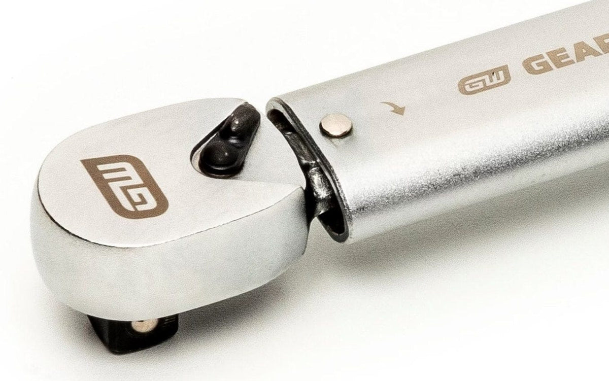 A close-up studio shot of the fixed 3/8-inch drive head of the preset torque wrench, showing the quick-release pin and the mechanism where the head meets the shaft.
