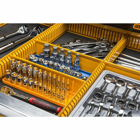 A close-up view of a drawer interior, showing tools organized within the yellow customizable partition system, including sockets, ratchets, and wrenches.