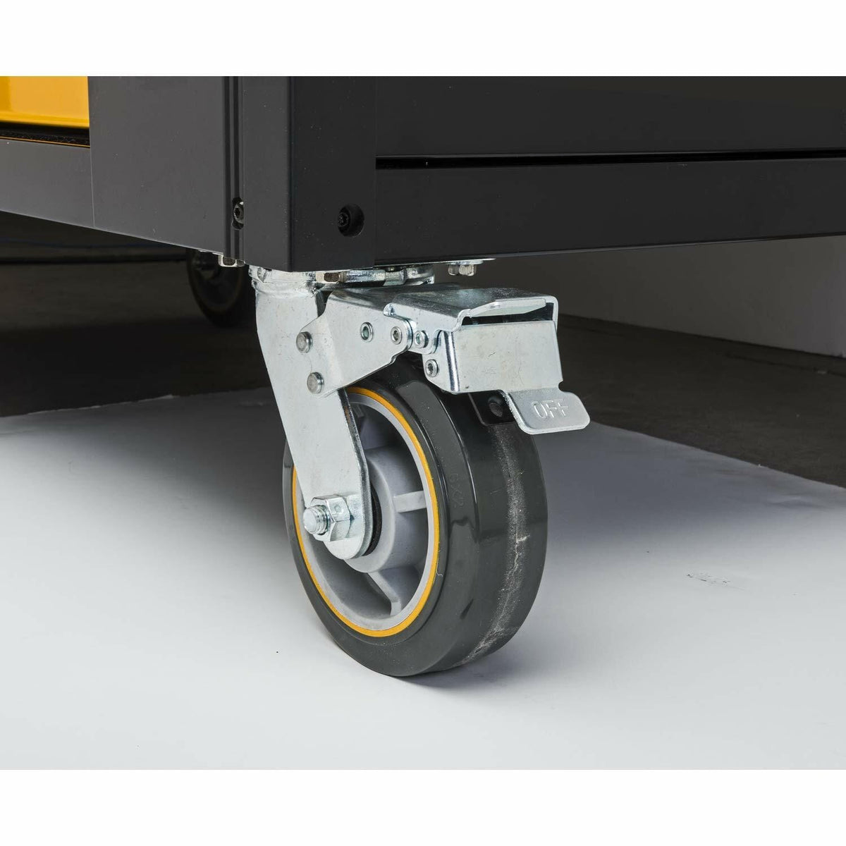 A close-up view of one of the heavy-duty, industrial-grade polyurethane caster wheels of the mobile work station, showing the locking mechanism engaged in the 'OFF' position.