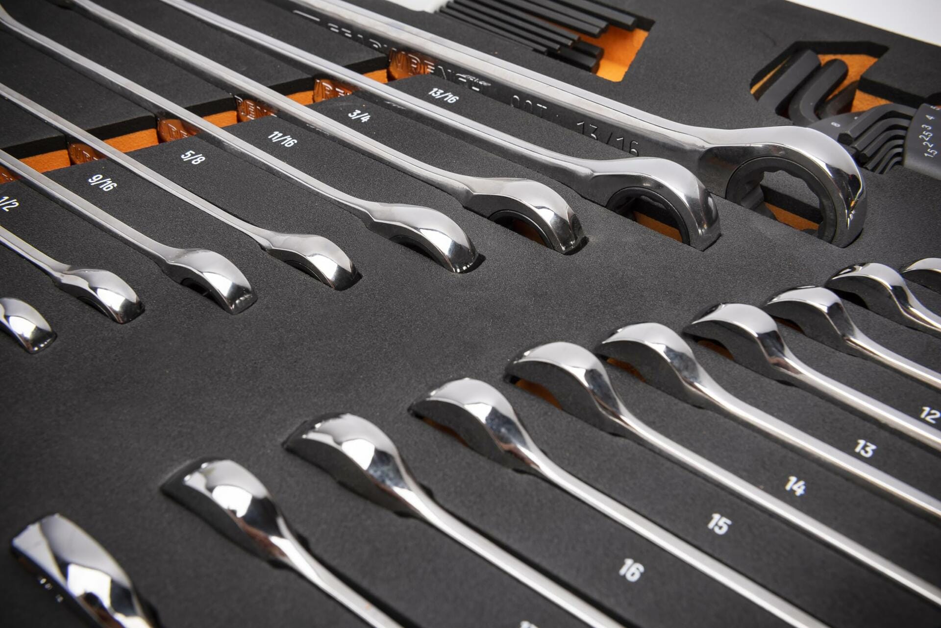  A foam tray containing polished chrome SAE combination wrenches arranged by size from 5/16" to 1". Each wrench is secured in a labeled slot, showing both open-end and box-end sides. The tray is designed for modular tool chest organization.